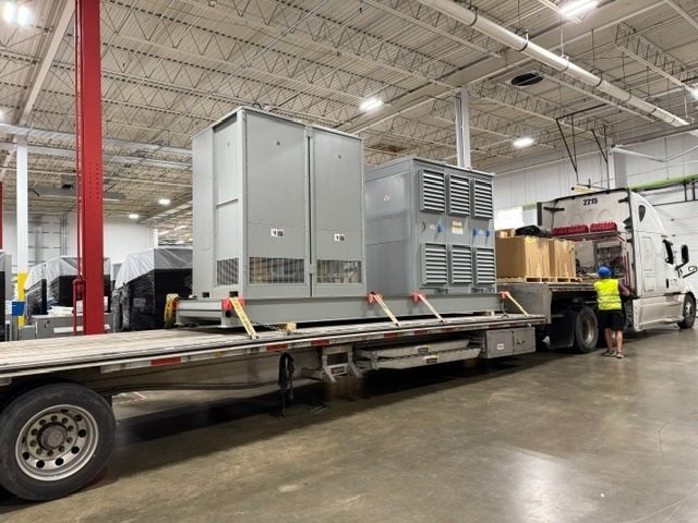 Resistive load bank secured on a flatbed trailer in a warehouse